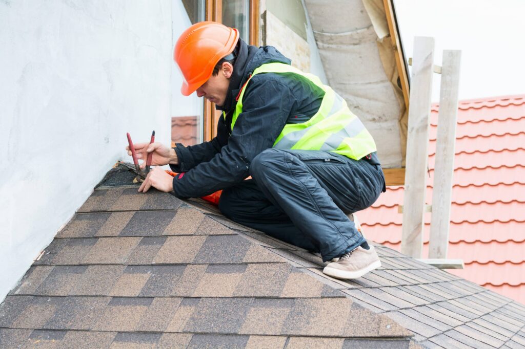 roofing contractor working on the top of a bay window