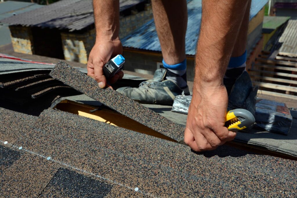 roofing contractor putting shingles down on a roof