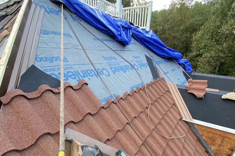 a damaged roof that is being repaired and financed through an insurance claim