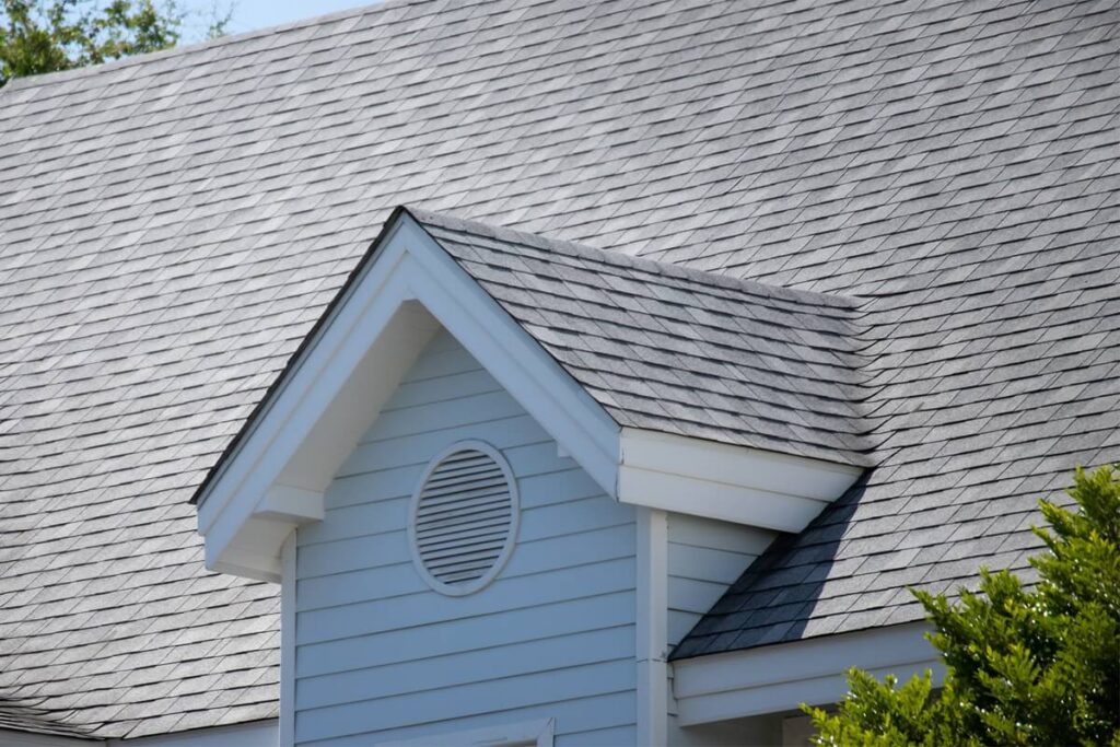 garret house and Roof shingles on top of the house among a lot of trees