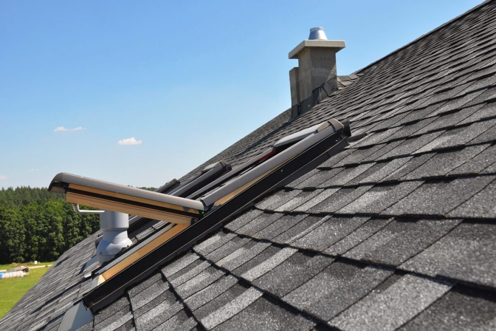 gray roof covered with dimensional architectural asphalt shingles with an attic skylight, ventilation pipe