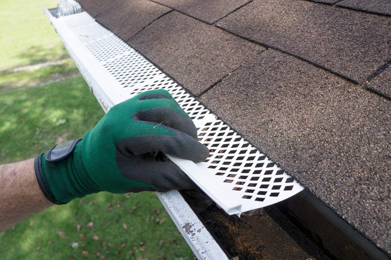 gutter guards being installed by a professional gutter contractor