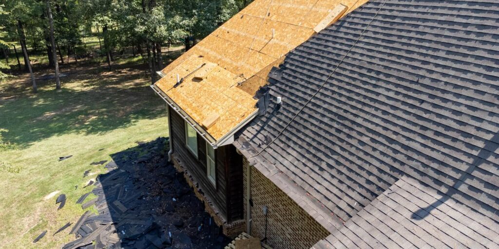 house with new roof being installed