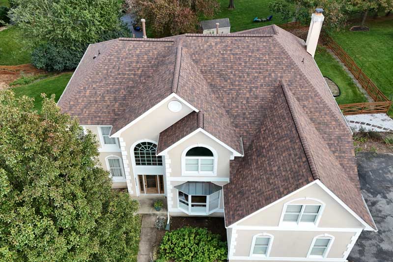 large home with a roof built by experienced roof replacement experts
