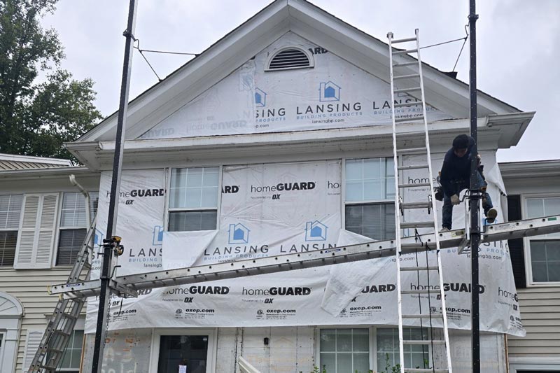 Northern VA siding contractors working on the front of a home