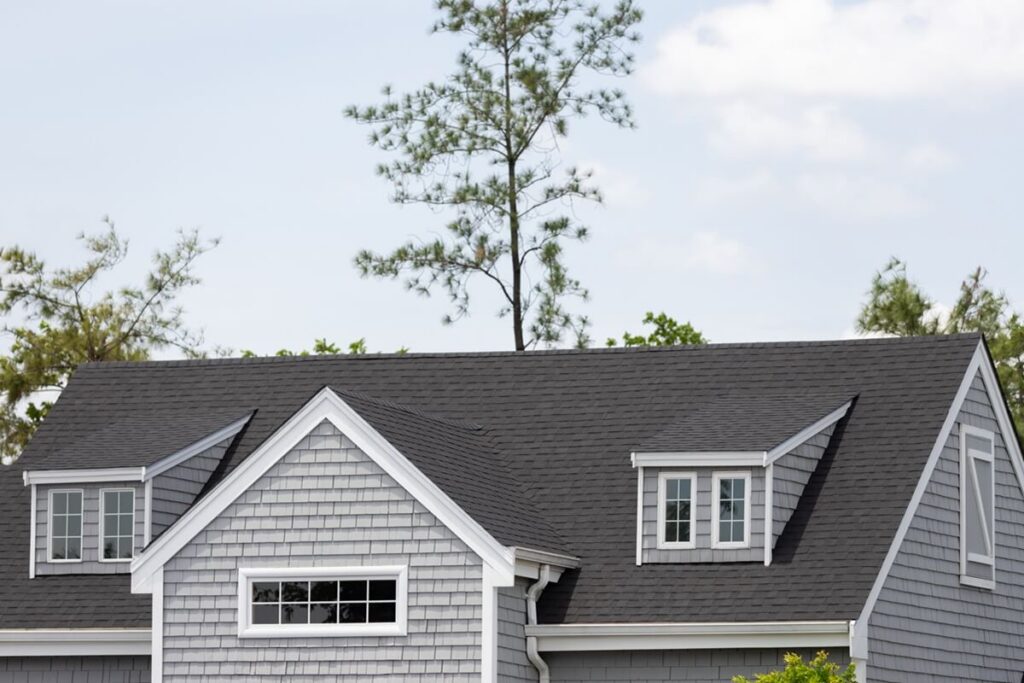 shingles with garret house on top of the house among a lot of trees