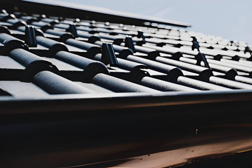 snow guards securing metal roof tiles, ensuring safety and preventing snow slides on a residential building