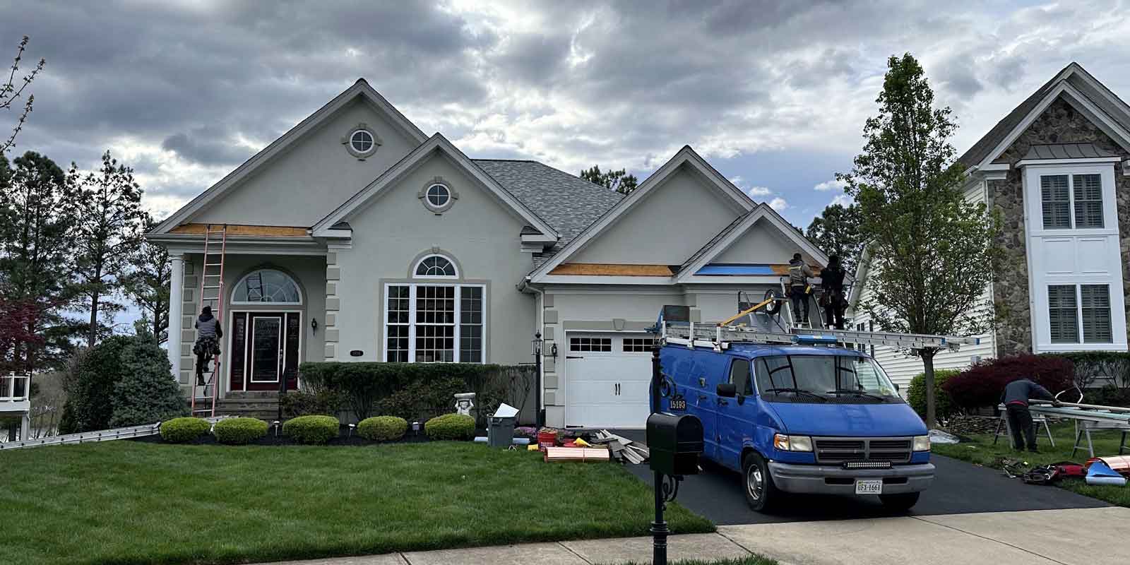 specialty siding contractors working on the side of a home