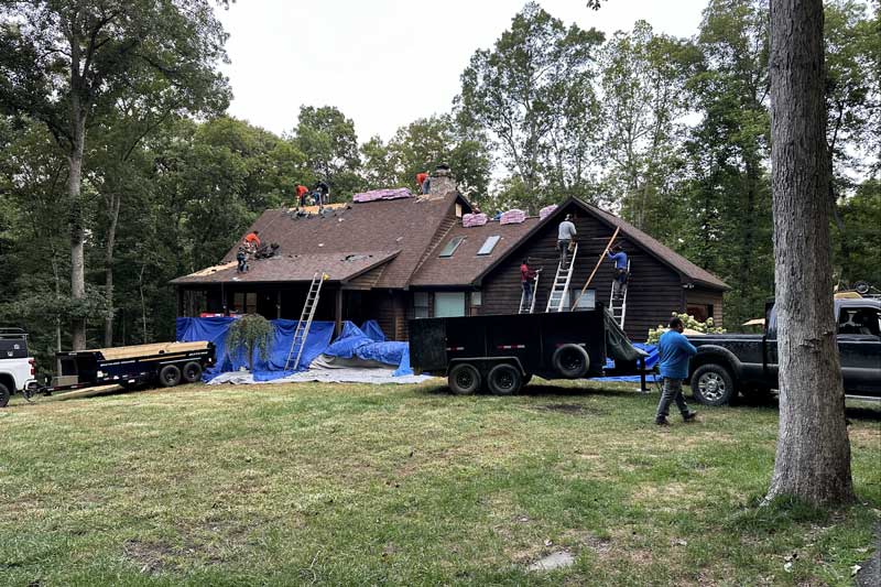the P
the Pure Roofing team assisting a home that has storm damage
