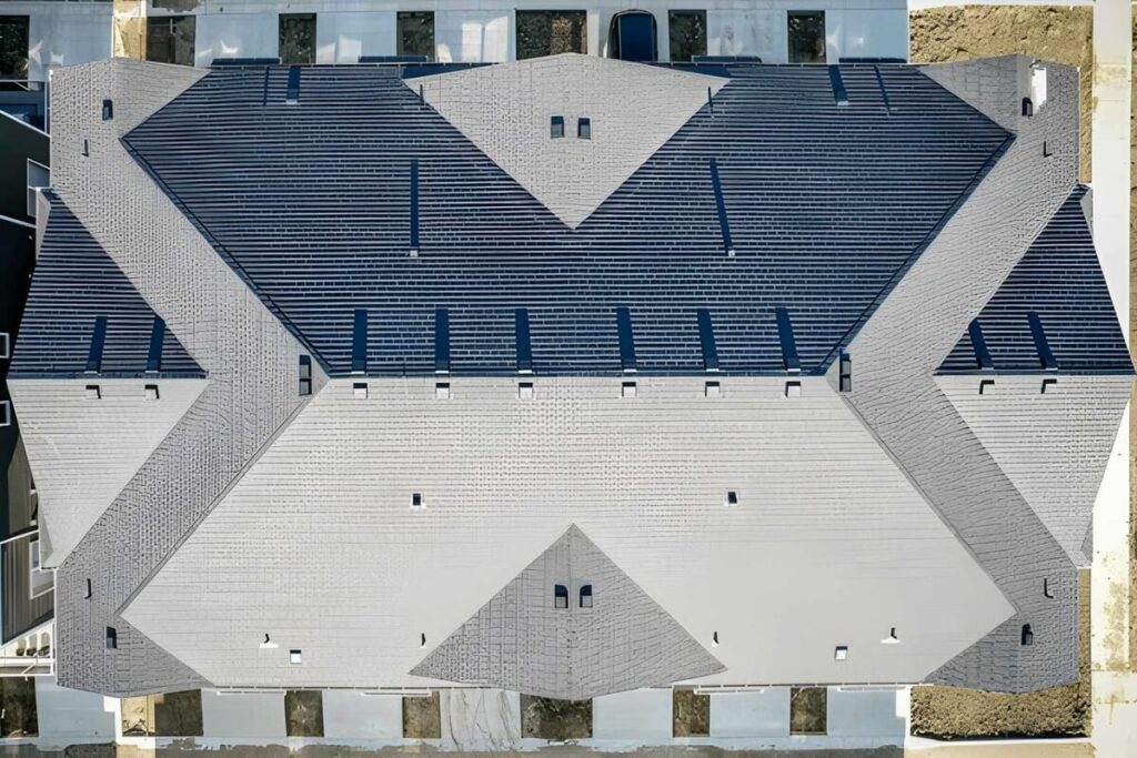 the roof of the house is slanted and has a blue and gray color