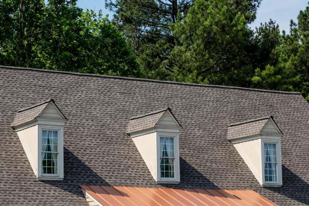 three dormers over asphalt and copper