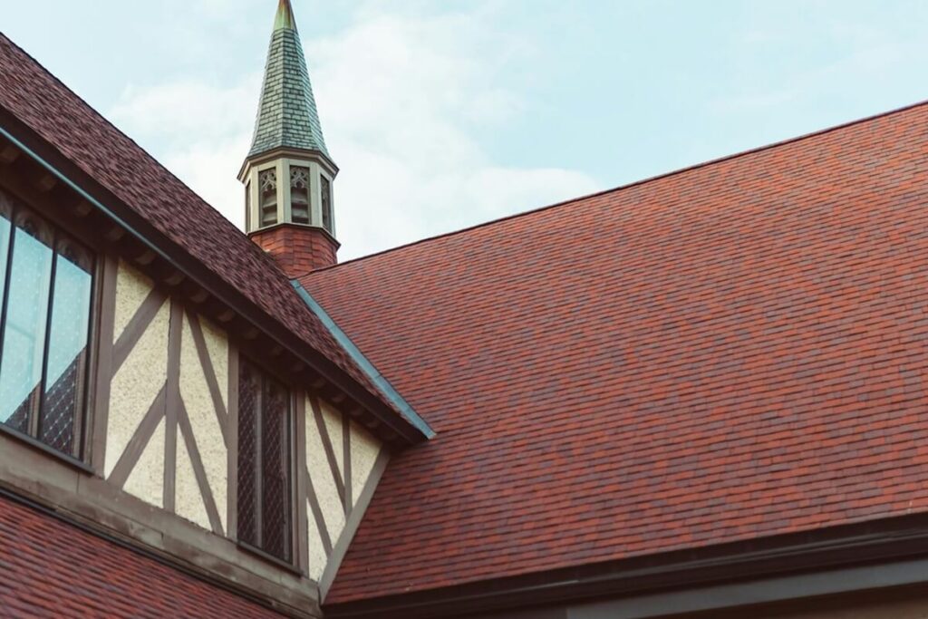 view of a church steeple with timbered architecture against a clear sky