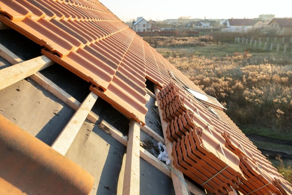yellow ceramic roofing tiles for covering residential building roof under construction