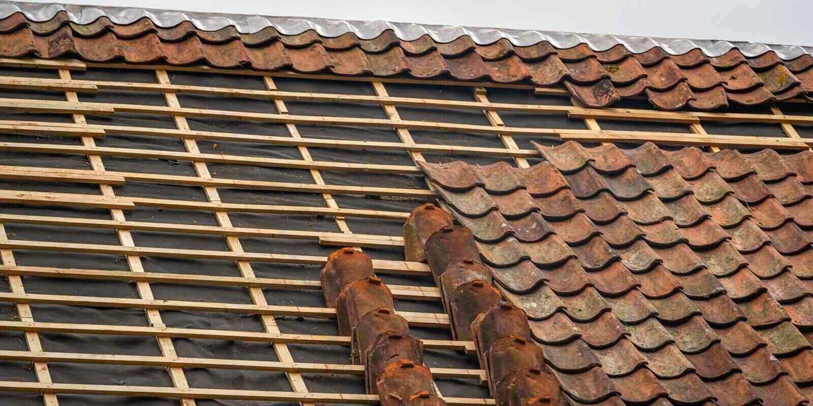 clay roof tile repair and replacement on old house during roof renovation
