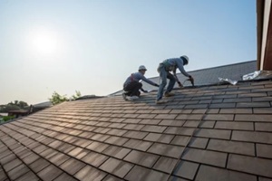 roofer worker in special protective work wear and gloves