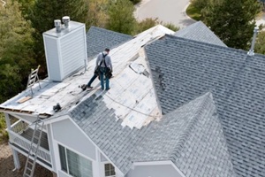 roofing contractor working on a residential home during roof replacement